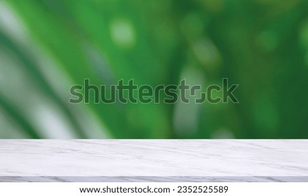 Empty white Marble Counter on blurred green foliage Background, suitable for product Mockup display Presentation