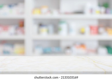 Empty White Marble Counter Top With Blur Pharmacy Drugstore Shelves Background