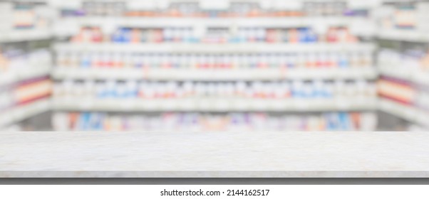 Empty White Marble Counter Top With Blur Pharmacy Drugstore Shelves Background