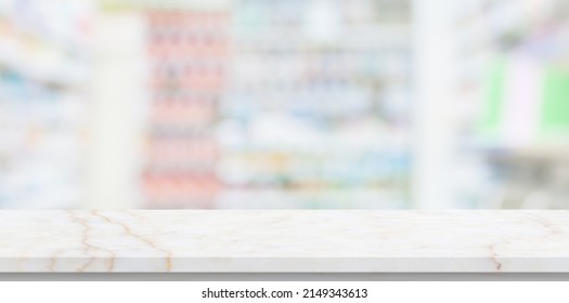 Empty White Marble Counter Top With Blur Pharmacy Drugstore Shelves Background