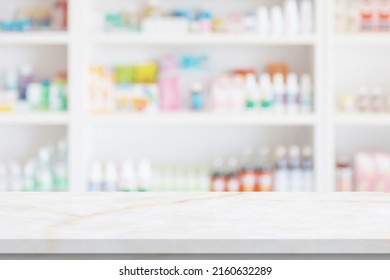 Empty White Marble Counter Top With Blur Pharmacy Drugstore Shelves Background