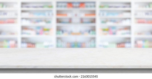 Empty White Marble Counter Top With Blur Pharmacy Drugstore Shelves Background