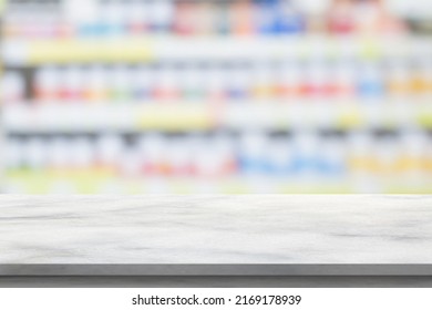 Empty White Marble Counter Top With Blur Pharmacy Drugstore Shelves Background