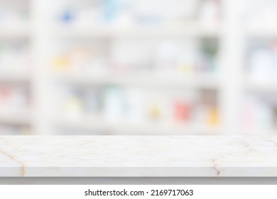 Empty White Marble Counter Top With Blur Pharmacy Drugstore Shelves Background