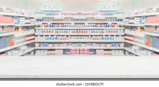 Empty White Marble Counter Top With Blur Pharmacy Drugstore Shelves Background