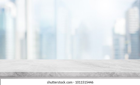 Empty white marble stone table top and blur glass window wall building with city view background - can used for display or montage your products.