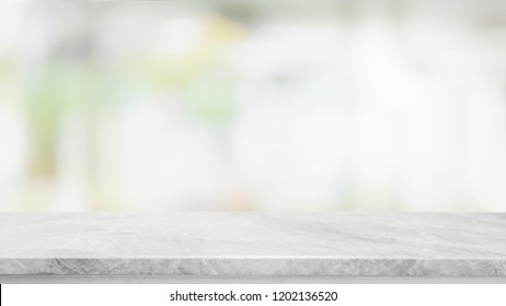 Empty white marble stone table top on blurred with bokeh shopping mall interior background - can be used for display or montage your products - Shutterstock ID 1202136520