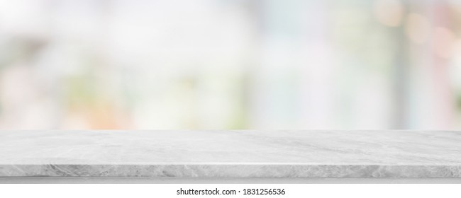 Empty white marble stone table top and blur glass window interior cafe and restaurant banner mock up abstract background - can used for display or montage your products.