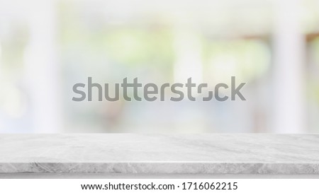 Empty white marble stone table top and blur glass window interior cafe and restaurant banner mock up abstract background - can used for display or montage your products.