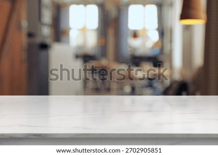 Empty white marble table in cafeteria, blurred background. Space for design