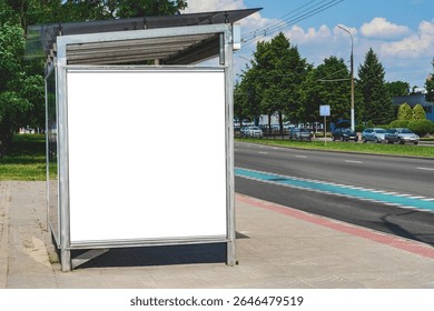 An empty white mock-up of a vertical light box at a bus stop