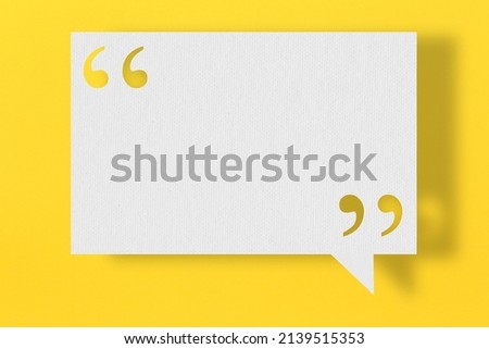 Empty white note paper floating on yellow art paper background and have quotation mark for design in your work.