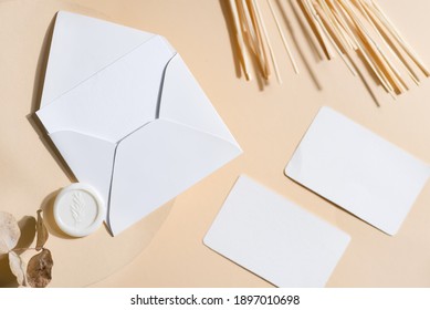 Empty White Paper Mock Up With Leaves On Beige Background. Holiday Marketing, Business Card And Email Newsletter Concept.