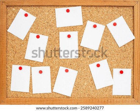 Empty white paper notes pinned and scattered on a cork board , abstract business backdrop