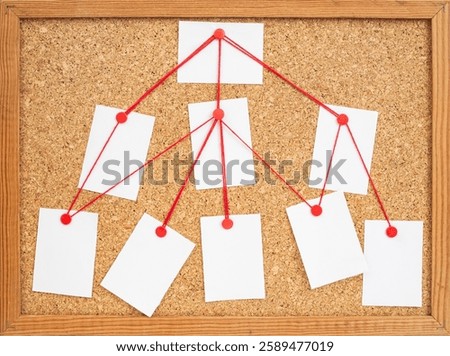 Empty white paper notes pinned and arranged on a cork board , abstract pyramidal business backdrop