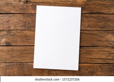 Empty White Paper Sheet On Rustic Wooden Table. Top View