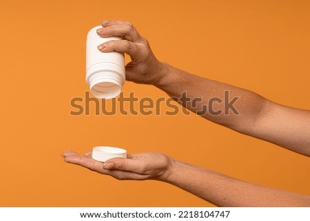 empty white plastic bottle in hand. ran out sweetener concept