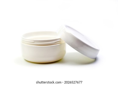 Empty White Plastic Opaque Cream Jar With Lid. Isolated On White Background. Cosmetic Product For Skin Care