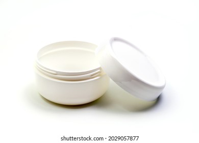 Empty White Plastic Opaque Cream Jar With Lid. Isolated On White Background. Cosmetic Product For Skin Care