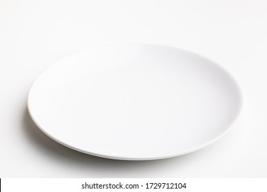 An Empty White Plate On White Background.