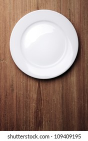 Empty White Plate On Wooden Table