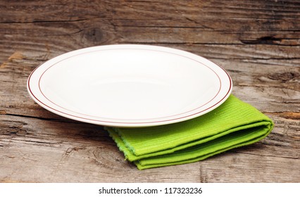 Empty White Plate On Wooden Table