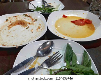 Empty White Plate On Wooden Table, Concept Of Eat Too Much Food To Make Fat  