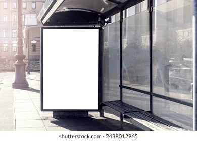 Empty white poster with mockup in lightbox on bus stop in front of urban city street with large glass window and bench. - Powered by Shutterstock