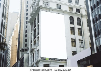 Empty White Poster On City Building. Public Ad And Commercial Concept. Mock Up 