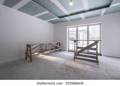 empty white room without repair and furniture with scaffolding