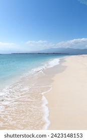 Empty white sandy beach with clear waters, Gili Islands, Indonesia