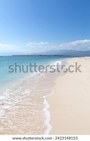 Empty white sandy beach with clear waters, Gili Islands, Indonesia