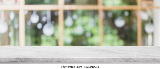 Empty white stone marble table top and blurred of interior restautant with window view green from tree garden background banner background - can used for display or montage your products. - Shutterstock ID 1530010013