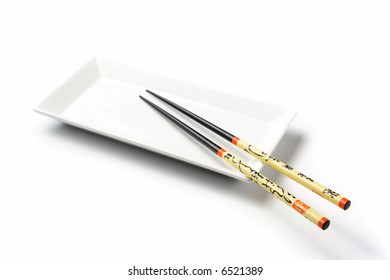 An Empty White Sushi Plate With Chopsticks Isolated On White Background