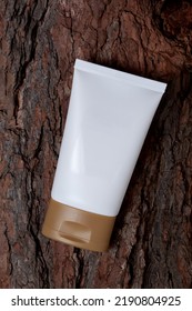 empty white tube of cream on the bark of a tree. concept organic cosmetics - Shutterstock ID 2190804925