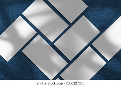 Empty White Vertical Rectangle Poster Or Business Card Mockups With Diagonal Rainbow Shadow On Blue Concrete Background. Flat Lay, Top View. For Advertising, Brand Design, Stationery Presentation.