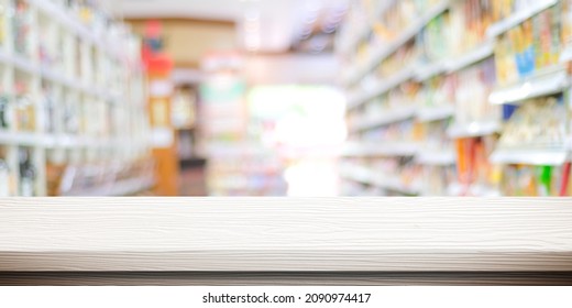 Empty White Wood Table Over Blur Product Shelf At Grocery Supermarket In Shopping Mall Background, For Product Display Montage, Template Background