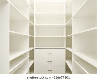 Empty White Wooden Home Walk-in Closet.