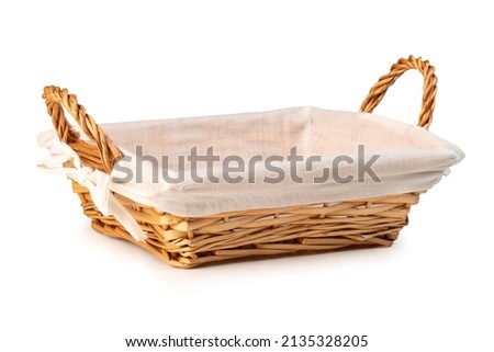 Empty wicker bread basket with white napkin isolated on a white background