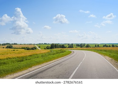 Empty winding highway through the endless fields and hills of the Oryol region, Oryol region of Russia
