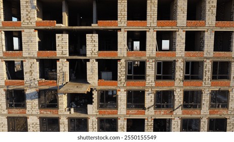Empty windows in the construction site building facade