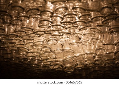 empty wine bottles hanging from a ceiling 