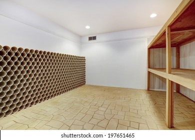 Empty wine cellar with wooden shelves and wine storage unit