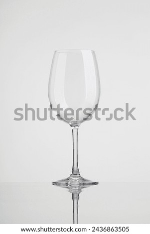 empty wine glass with reflection. Empty wine glass isolated on white background. Transparent wine glass.