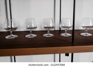 Empty Wine Glasses On The Bar Shelf. Set Of Wineglasses 