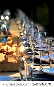 empty wine glasses on the table, illuminated by the evening sun 