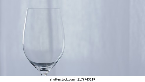 Empty Wineglass With Curtains On Background