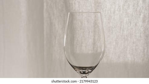 Empty Wineglass With Curtains On Background