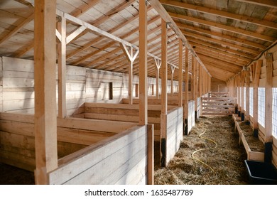 Empty woden stable/ barn with hay  on the floor
