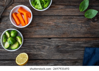 Empty woden table with vegetables, lemon and napkin on side. Top view
